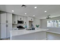 Modern kitchen features an island, stainless steel appliances, and white cabinets at 2004 Burnham Ave, Las Vegas, NV 89104