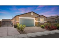 Charming single-story home featuring desert landscaping, a two-car garage, and a secure gated entrance at 2091 Hunt Woods Ct, Laughlin, NV 89029