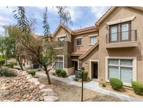 Charming townhouse featuring desert landscaping, a private balcony, and a well-maintained exterior at 2787 Fountain Ridge Ln, Henderson, NV 89074
