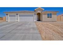 Charming single-story home featuring a spacious three-car garage and a modern design on a sunny day at 4930 E Ridgewood, Pahrump, NV 89061