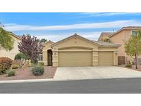 Charming single-story home featuring a three-car garage and well-maintained desert landscaping at 5835 Farmhouse Ct, Las Vegas, NV 89141