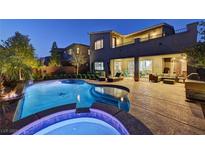 A luxurious backyard featuring a pool and spa with an outdoor living space, perfect for entertaining at 6491 Wild Blue Ct, Las Vegas, NV 89135