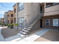 Apartment building featuring a modern design, exterior staircase, and well-maintained landscaping at 6650 W Warm Springs Rd # 1079, Las Vegas, NV 89118