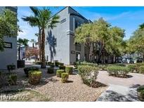 Beautiful exterior view of a modern condo building with a well-maintained landscape design at 9050 W Tropicana Ave # 1009, Las Vegas, NV 89147