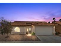 Charming single-story home featuring a well-maintained front yard, two-car garage, and tiled roof at 1403 Bareback Ct, Henderson, NV 89014