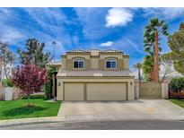 Charming two-story home featuring a well-manicured lawn, mature trees, and a convenient two-car garage at 2073 Sapphire Valley Ave, Henderson, NV 89074