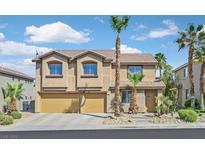Charming two-story home featuring a two-car garage, desert landscaping, and mature palm trees at 24 Painted View St, Henderson, NV 89012
