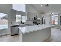 Bright kitchen features an island, stainless steel appliances, and light wood floors at 6549 Gazelle Dr, Las Vegas, NV 89108