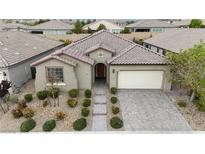 Charming single-story home featuring a tile roof, paver driveway, and well-manicured landscaping at 8393 Canyon Crevasse St, Las Vegas, NV 89166