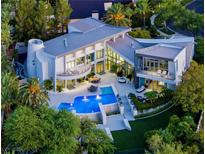 Striking aerial view of a luxury home with a private pool, patio, and lush landscaping at 1108 Pine Island Ct, Las Vegas, NV 89134