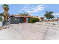 Charming single-story home with a well-maintained front yard and a vibrant red front door at 1408 E Carson Ave, Las Vegas, NV 89101