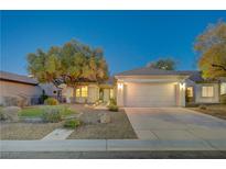 Charming single-story home featuring a two-car garage, complemented by manicured landscaping and mature trees at 2088 Mountain City St, Henderson, NV 89052