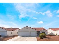 Charming single story home featuring a two car garage and a well maintained front yard at 2117 Mountain Sunset Ave, North Las Vegas, NV 89031