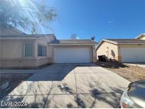 Charming single-story home featuring a two-car garage and a well-maintained driveway under a clear, sunny sky at 5316 Clover Blossom Ct, North Las Vegas, NV 89031