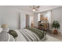 Bright bedroom featuring a ceiling fan, console table, and stylish bedding at 6808 Elm Creek Dr # 203, Las Vegas, NV 89108