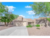Charming single-story home featuring a well-manicured front yard and a two-car garage at 8620 Prairie Hill Dr, Las Vegas, NV 89134