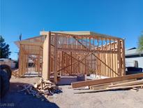 Image of new construction with the wooden frame under a clear blue sky at 1329 Price St, Henderson, NV 89011
