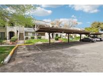 Condos with covered parking, landscaped grounds, and stairs leading to each unit at 1404 Santa Margarita St # D, Las Vegas, NV 89146