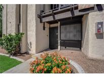 Inviting front entrance with a black security door and well-maintained landscaping and stucco at 1440 Vegas Valley Dr # 1, Las Vegas, NV 89169