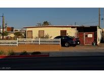 Charming single-story home with a white picket fence and a car parked in front at 203 W Pacific Ave, Henderson, NV 89015