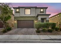 Two story home with a two car garage and landscaped yard, enhancing the property's curb appeal at 5232 Mountain Garland Ln, North Las Vegas, NV 89081