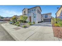 Two-story home boasts a landscaped front yard and a spacious driveway leading to a two-car garage at 5712 Almocita Ct, Las Vegas, NV 89141