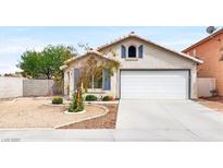 Charming single-story home featuring a two-car garage, desert landscaping, and plenty of curb appeal at 5954 Rose Sage St, North Las Vegas, NV 89031