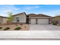 Attractive single-story home with a three-car garage and desert landscaping at 6261 Lamont Hills Ave, Las Vegas, NV 89139