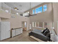 Bright bedroom with soaring ceilings, large windows, and neutral tones at 6647 Rego Park Ct, Las Vegas, NV 89166