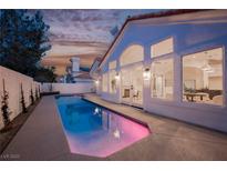Stunning backyard pool reflecting the house and the sunset, adding an element of luxury and relaxation at 8140 Bay Harbor Dr, Las Vegas, NV 89128