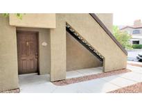 Beige stucco exterior with a brown door and the unit number, with stairs leading to a second level at 9000 Las Vegas Blvd # 1074, Las Vegas, NV 89123
