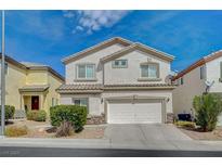 Inviting two-story home featuring a stucco facade, tile roof, and an attached two-car garage at 9732 Kampsville Ave, Las Vegas, NV 89148