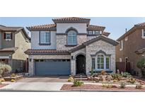 Charming two-story home featuring stone accents, a two-car garage, and desert landscaping in a well-maintained neighborhood at 1136 Jamesbury Rd, Las Vegas, NV 89135