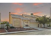 Inviting two-story home with a tile roof, landscaped front yard, and attached two-car garage at 1705 Desert Ridge Ave, North Las Vegas, NV 89031