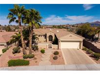 Charming single-story home with a well-manicured front yard, desert landscaping, and a two-car garage at 1908 Oliver Springs St, Henderson, NV 89052