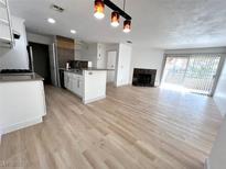 Bright open-concept living room features a fireplace and sliding glass doors at 2200 S Fort Apache Rd # 2123, Las Vegas, NV 89117