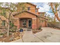 Charming two-story home featuring a covered porch, desert landscaping and a tile roof at 5050 Secret Rock St, Las Vegas, NV 89122