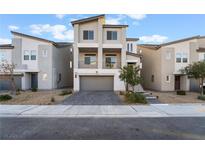 Contemporary two-story home with a well-manicured front yard and attractive architectural details at 5745 Becklow Gardens Ave, Las Vegas, NV 89141