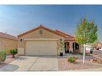 Charming single-story home with a two-car garage and a meticulously landscaped front yard at 713 Salt Flats Cir, Henderson, NV 89011
