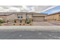 Charming single-story home with a two-car garage and manicured landscaping at 7525 Campbell Ranch Ave, Las Vegas, NV 89179
