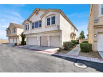 Modern townhouse featuring a three-car garage and well-maintained landscaping at 9322 Straw Hays St # 101, Las Vegas, NV 89178