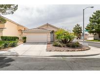 Charming single-story home with a well-maintained front yard and attached two-car garage at 1966 Flagstone Ranch Ln, Henderson, NV 89012