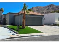 Charming single-story home with mature landscaping, a two-car garage, and a mountain backdrop at 2370 Ray Kanel Dr, Las Vegas, NV 89156