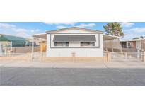 Charming single-story home featuring awnings, low fencing, and well-maintained front yard at 3540 Estes Park Dr, Las Vegas, NV 89122