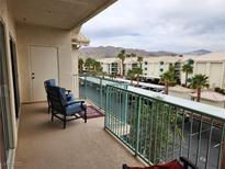 Enjoy serene mountain views from this spacious balcony featuring comfortable seating and stylish decor at 3550 Bay Sands Dr # 3077, Laughlin, NV 89029