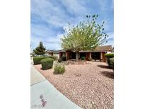 Charming single-story home with mature landscaping, decorative rock ground cover, and a large tree at 5268 Caspian Dr, Las Vegas, NV 89118