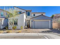 Charming two-story home with a well-maintained front yard and a two-car garage at 6 Lilla Rosa St, Henderson, NV 89011