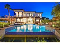 Beautiful backyard pool with stylish lounge seating and lush landscaping at 6 Rue Du Ville Way, Henderson, NV 89011