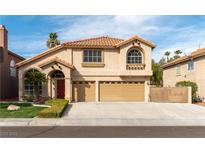 Charming two-story home featuring a terra cotta tile roof and a three car garage at 9843 Frosty Canyon Ct, Las Vegas, NV 89183