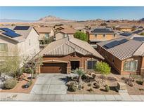 Single story home featuring a well-manicured front yard, desert landscaping, and tile roof at 132 Soaring Sky Ave, Henderson, NV 89011